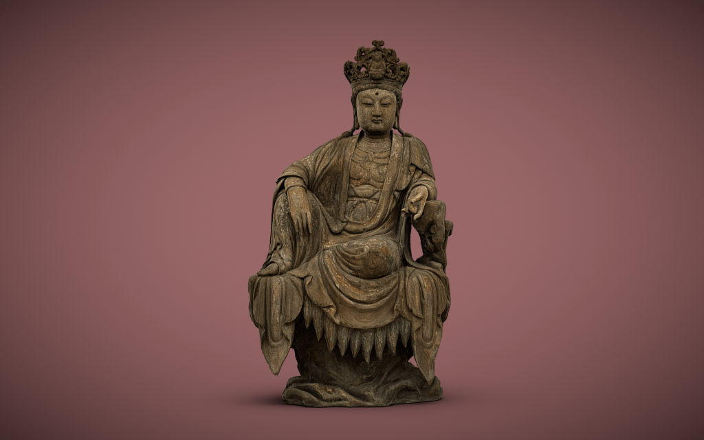 The image shows a statue of a seated bodhisattva, Guanyin (Avalokiteshvara), a revered figure in East Asian Buddhism known for compassion. The figure is adorned in flowing robes and a detailed crown, seated in a relaxed pose with one leg hanging down and one arm resting on a support, conveying both grace and serenity.